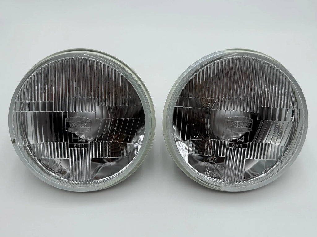 Pair of round 7in BMW 2002 headlights on a white background