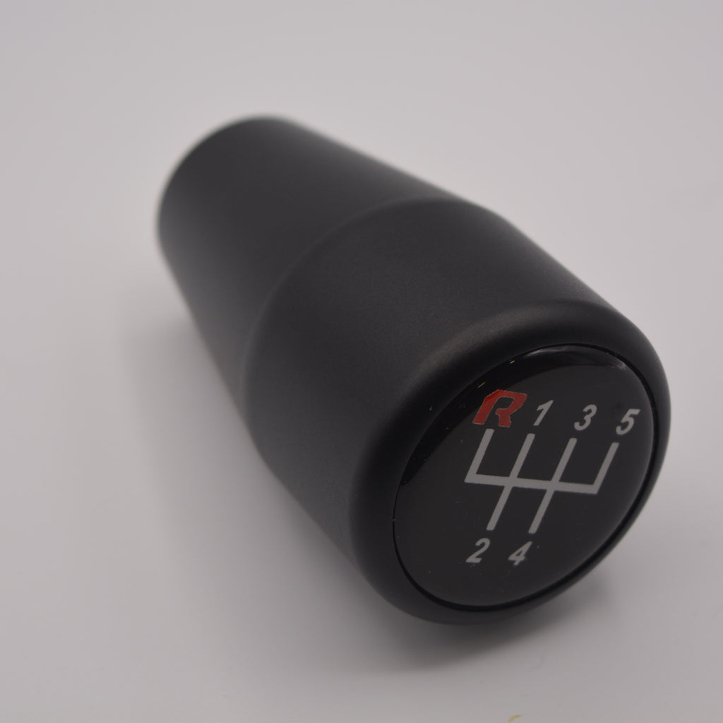 Black HRB gear shift knob with number markings on a gray background