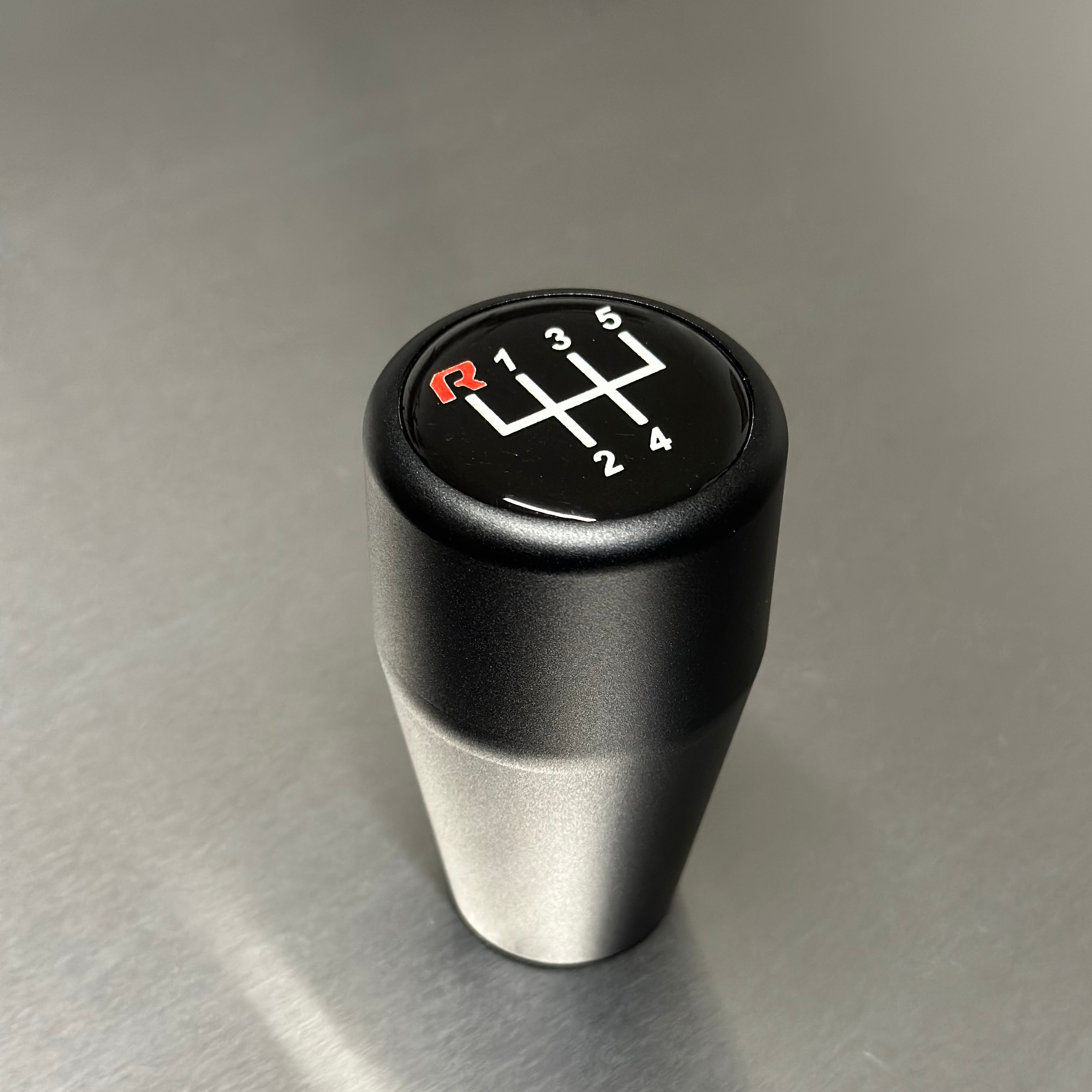 HRB BMW gear shift knob with six-speed symbol on a metallic surface