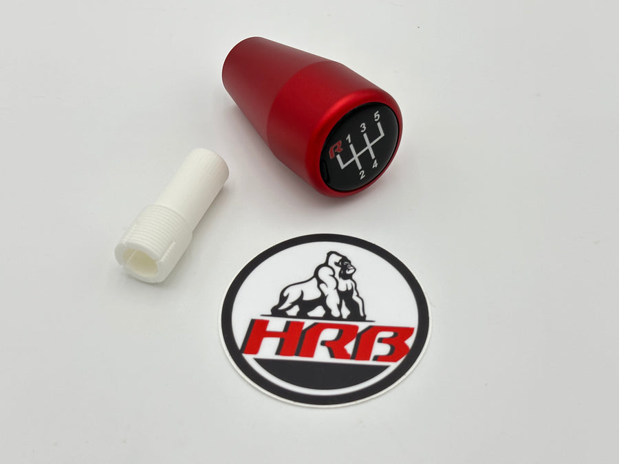 Red gear shift knob with a sticker featuring 'HRB' logo on a white background