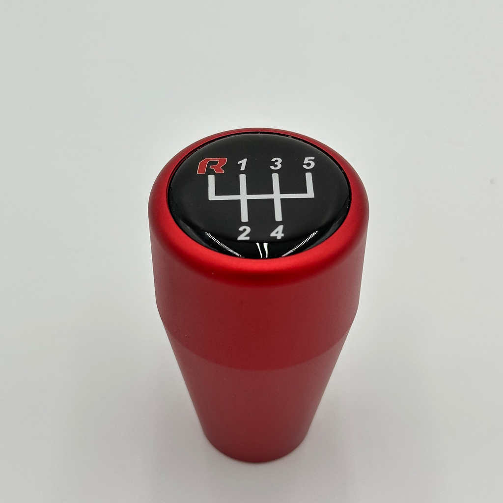 Red BMW HRBERFORMANCE gear shift knob with a black dial on a white background