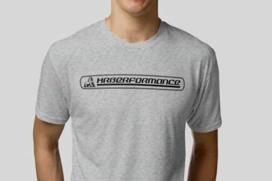Person wearing a gray t-shirt with 'Hrberformance' logo on a plain background