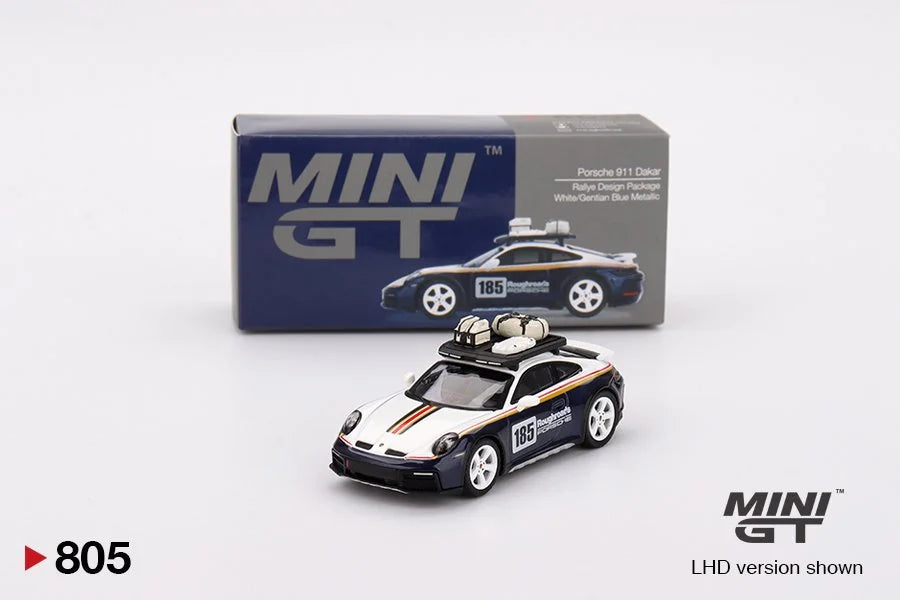 Miniature Porsche 911 Dakar with roof rack in front of its packaging box, featuring 'MINI GT' branding.
